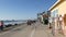 People walking, waterfront promenade beachfront boardwalk. Ocean beach near Los Angeles, California USA