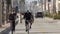 People walking, waterfront promenade beachfront boardwalk. Ocean beach near Los Angeles, California USA