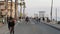 People walking, waterfront promenade beachfront boardwalk. Ocean beach near Los Angeles, California USA