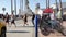 People walking, waterfront promenade, beachfront lifeguard. Ocean beach near Los Angeles, California