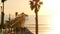 People walking, wooden pier in California USA. Oceanside waterfront vacations tourist resort.