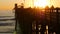 People walking, wooden pier in California USA. Oceanside waterfront vacations tourist resort.