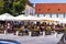 People wandering and having lunch at local restaurants on the streets of Sibiu old town during coronavirus crisis. Sibiu, Romania