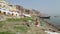 People washing and drying laundry on string on shore of Ganges.