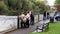 People watch as  Salmon leap a weir