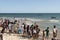 People watching fishermen in canoes inside the sea