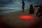 People watching hatchlings highlighted by flashlight scurrying to the water during Olive ridley sea turtle release