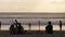 People watching the ocean water and the horizon