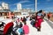 People are watching a performance of a puppet theater in Brighton, i360 tower