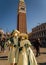 People wearing elaborate and colorful costumes and masks during the Venice carnival in Venice, Italy