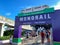 People wearing face masks and social distancing while waiting in line to get on the monorail at  Walt Disney World Resorts in