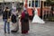 People wearing islamic scarf taking wedding pictures with smartphones of a newly married couple