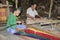 People weaving sedge grass mats.