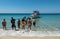 People welcome a tour boat on the island of Donousa Greece.