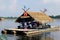 People, which is not known, is sitting in the platform in the lake