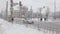 People in winter stand at the traffic light at the pedestrian crossing in cloudy cloudy weather