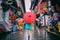 People woman walking in chinatown shopping street. Rainy day girl tourist under red oriental umbrella in narrow alleys