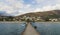 People in wood pier over Plav lake. Fisherman small coast town with ferryboats in Montenegro