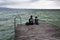 People on wooden pier on Lago di Garda in Sirmione, Italy