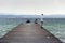 People on wooden pier on Lago di Garda in Sirmione, Italy