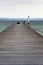 People on wooden pier on Lago di Garda in Sirmione, Italy