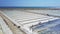 People Work on Salt Plantations against Azure Ocean