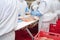 People working at a chicken factory - stock photo.Production line with packaging and cutting of meat