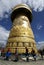 People worshipping with a big prayer wheel in Shangri-la in Yunnan, China