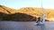 People on yacht on background of shadow and sunlight on mountain in Turkey.