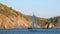 People on yacht on background of shadow and sunlight on mountain in Turkey.