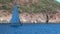 People on yacht on background of shadow and sunlight on mountain in Turkey.