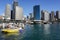 People with yellow passenger speed boat at harbour