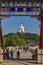 People on Yongan Bridge in Beihai Park with the Jade Island, Bai Ta (White Pagoda or Dagoba) stupa and Buddhist Yong An (Temple o