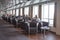 Peoples sat in a chairs in the public seating area inside a ferry by the window