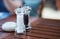 Pepper and grained salt in transparent grinder on table with copy space