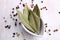 Pepper grains and leaves in bowls