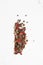 Pepper mix. Black, red, green, white and all spice peppercorns isolated on white background. Heap of spice. Mix of different