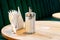 Pepper shakers and salt shakers, a napkin stand are on the table in a cafe. The table in the restaurant is covered with a