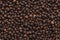 Peppercorn background. Dry black pepper seeds. Top view. Flat design. Macro spice background