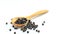 Peppercorn with wooden spoon on white background. Composition is