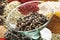 Peppercorns in glass, a selection of spices in background