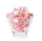 Peppermint candy in glass bowl on white. Red striped mint Christmas candy