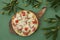 Pepperoni Pizza with Mozzarella cheese, sausages salami, Spices, tomato, olive and branch of olive for decoration. Italian pizza