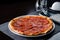 Pepperoni pizza set table with knife and fork