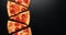 Pepperoni pizza slice on black slate background