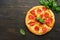 Pepperoni pizza. Traditional pepperoni pizza and cooking ingredients tomatoes basil on wooden table backgrounds. Italian