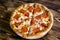 Pepperoni Pizza. On a wooden brown background.