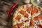 Pepperoni Pizza. On a wooden brown background.