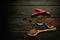 Peppers and spices on a black vintage table prepared for adding to food. Free space for menu or recipe