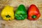 Peppers in three colours on a kitchen breadboard. Preparing vegetables for a healthy salad